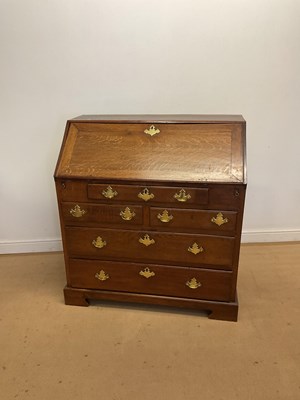 Lot 682 - A large oak Georgian bureau with brass...