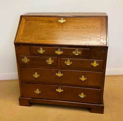 Lot 873 - A large oak Georgian bureau with brass...