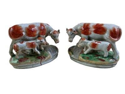 Lot 307 - A pair of Staffordshire style cows with calves,...