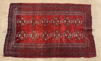 Lot 812 - A hand woven Persian style rug deep red in...