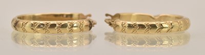 Lot 1492 - A pair of 9ct yellow gold hoop earrings with...