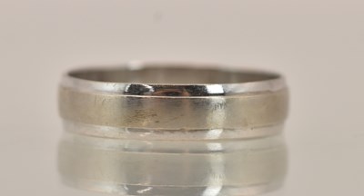 Lot 1409 - A 9ct white gold band ring, size M, approx 1.5g.