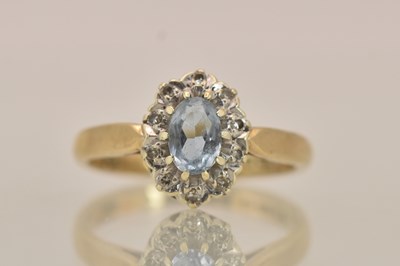 Lot 1407 - A 9ct yellow gold ring, with claw set cut blue...
