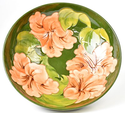 Lot 133 - MOORCROFT; a green ground 'Hibiscus' pattern...