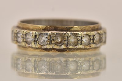 Lot 1399 - A 9ct white and yellow gold eternity ring,...