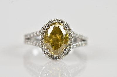 Lot 448 - A diamond halo split shank dress ring, with...