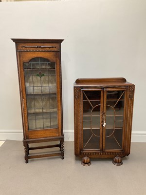 Lot 1114 - An early 20th century oak display cabinet with...