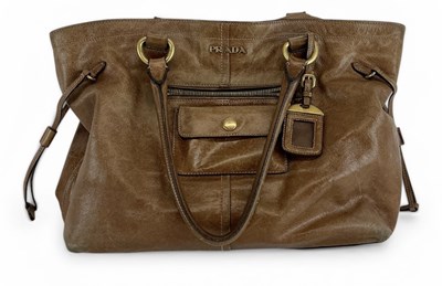 Lot 573 - PRADA; a lady's tan leather 'Vitello Daino'...