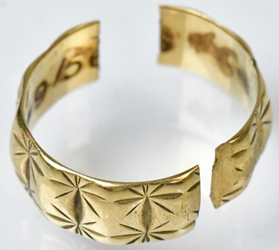 Lot 730 - A 9ct gold textured band ring, marked 375,...