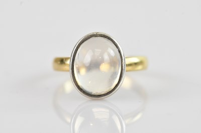 Lot 647 - A yellow metal moonstone cabochon ring, tests...