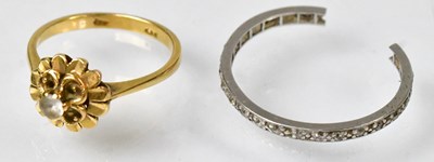 Lot 752 - A 9ct gold ring with a white stone in a floral...