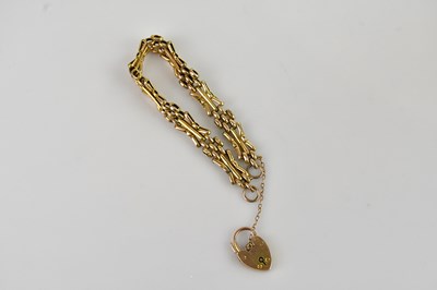 Lot 106 - A yellow metal gate link bracelet with 9ct...