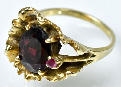 Lot 727 - A 14ct gold ring with a large garnet and small...