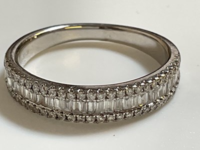 Lot 549 - A 14ct white gold and diamond half eternity...