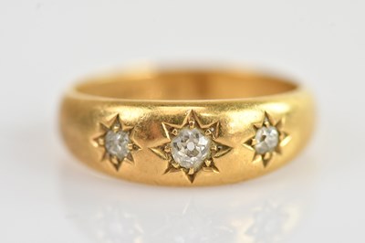 Lot 585 - A yellow metal diamond set three stone star...