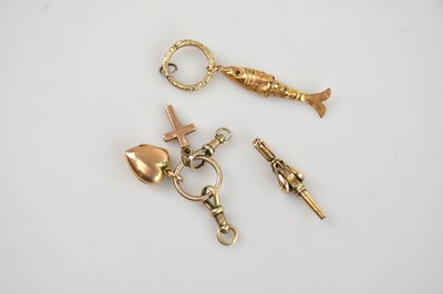 Lot 21 - A yellow metal charm formed as an articulated...