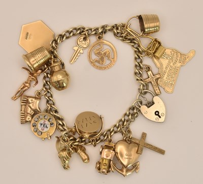 Lot 1514 - A 925 silver charm bracelet, with twenty 9ct...