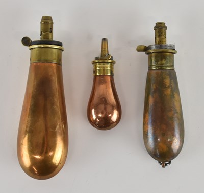 Lot 430 - Three copper powder flasks of graduated size,...