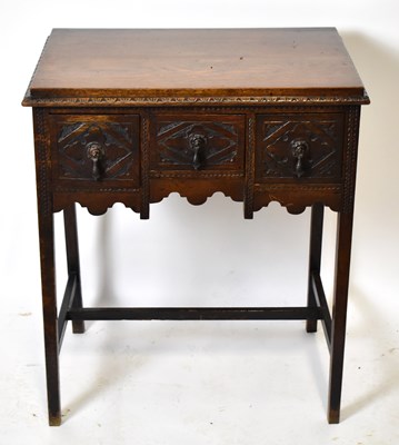 Lot 1613 - A George III oak lowboy