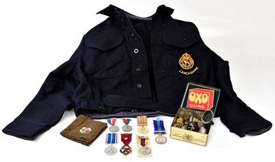 Lot 697 - A WWII warden's blue felt jacket with...