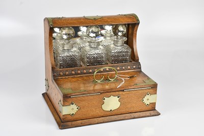 Lot 1197 - A Victorian golden oak tantalus, with three...