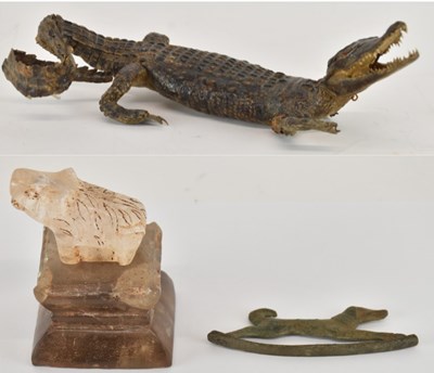 Lot 557 - An ancient bronze figure of a dog, on rounded...
