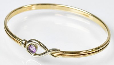 Lot 773 - A 9ct yellow gold bangle with base metal core,...
