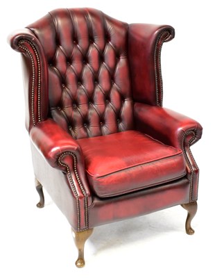 Lot 19 - A contemporary oxblood red leather button...