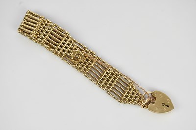 Lot 465 - A 9ct gold gate link bracelet, with heart...