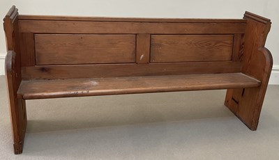 Lot 1044 - A late 19th century pitch pine pew, length 177cm.