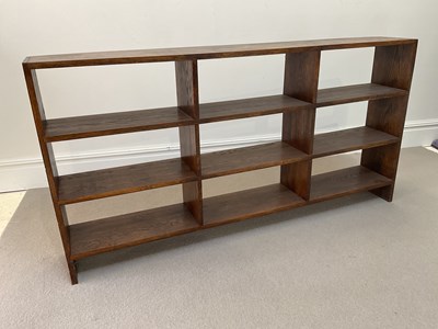 Lot 1053 - A stained oak open bookcase, with nine open...