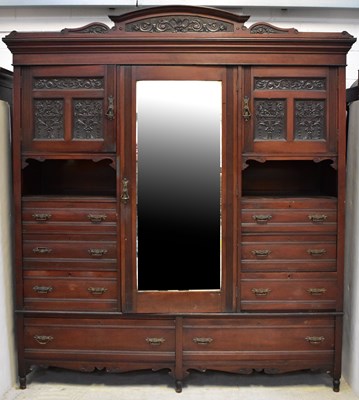 Lot 62 - An Edwardian mahogany triple wardrobe, the...