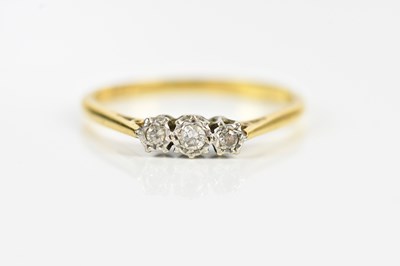 Lot 591 - A yellow and white metal diamond three stone...