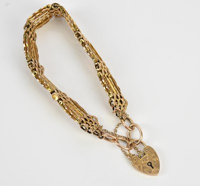 Lot 114 - A yellow metal textured gate link bracelet...