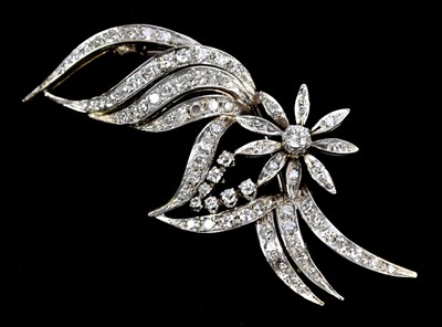 Lot 148 - A white metal diamond set floral brooch, set...