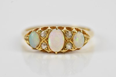 Lot 562 - An 18ct yellow gold diamond and opal seven...
