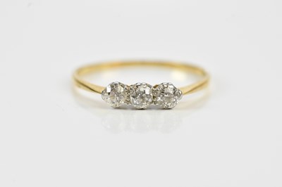 Lot 586 - A yellow metal diamond three stone dress ring,...