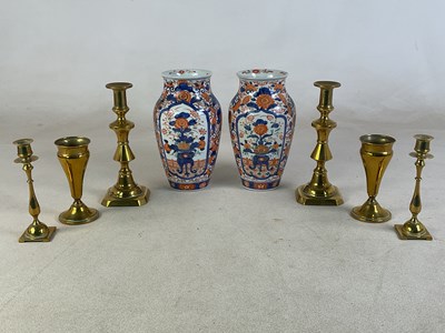 Lot 757 - Two pairs of decorative brass candlesticks and...