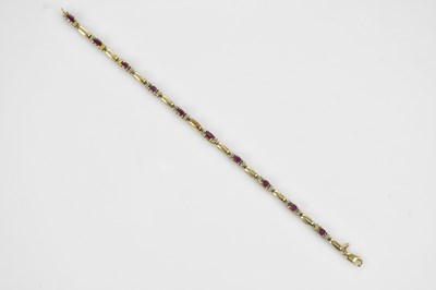 Lot 132 - A yellow metal fancy bracelet, set with red...