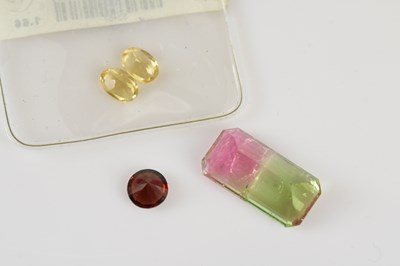 Lot 46 - LOOSE GEMSTONES; a round brilliant cut garnet,...
