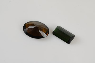 Lot 51 - LOOSE GEMSTONES; an emerald cut green...