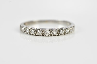 Lot 575 - A white metal diamond nine stone half etermity...