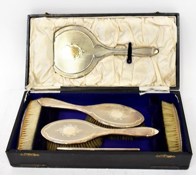 Lot 857 - A George V hallmarked silver backed six-piece...