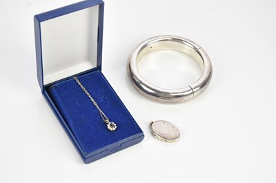 Lot 776 - A white metal circular bangle and a sterling...
