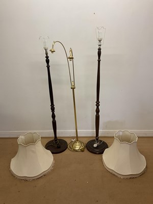 Lot 657 - Two standard lamps with shades, together with...