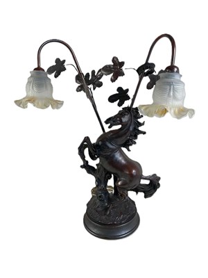Lot 658 - A cast metal lamp base in the form of a...