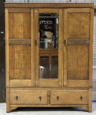 Lot 778 - A three door oak wardrobe over two drawers,...