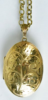 Lot 797 - A 9ct yellow gold oval locket with foliate...
