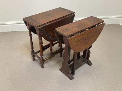 Lot 2069 - A 1920s carved oak drop-leaf occasional table,...
