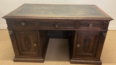 Lot 777 - An oak carved pedestal desk, the top having...